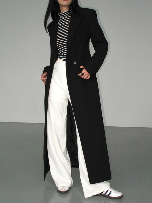 Women's long black single-breasted coat with notched lapels and front pockets