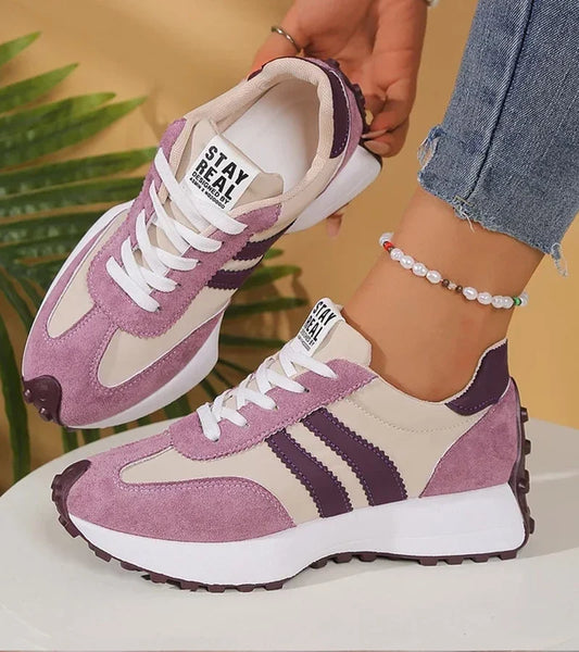 Low-top striped lace-up sneakers with contrasting panels and textured soles