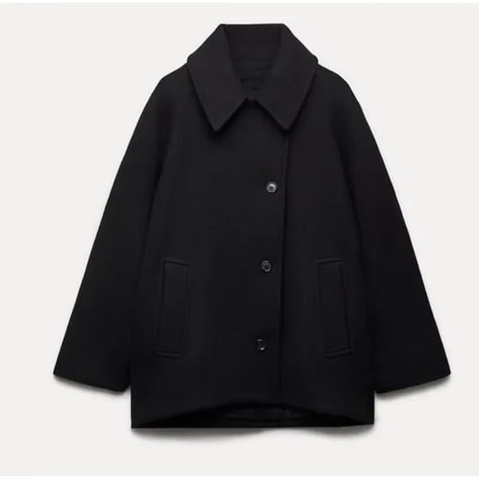 Women's oversized coat with point collar, button front and two welt pockets