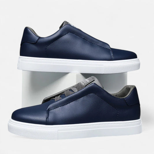 Men's low-top slip-on sneakers with stitched panels and flat white soles