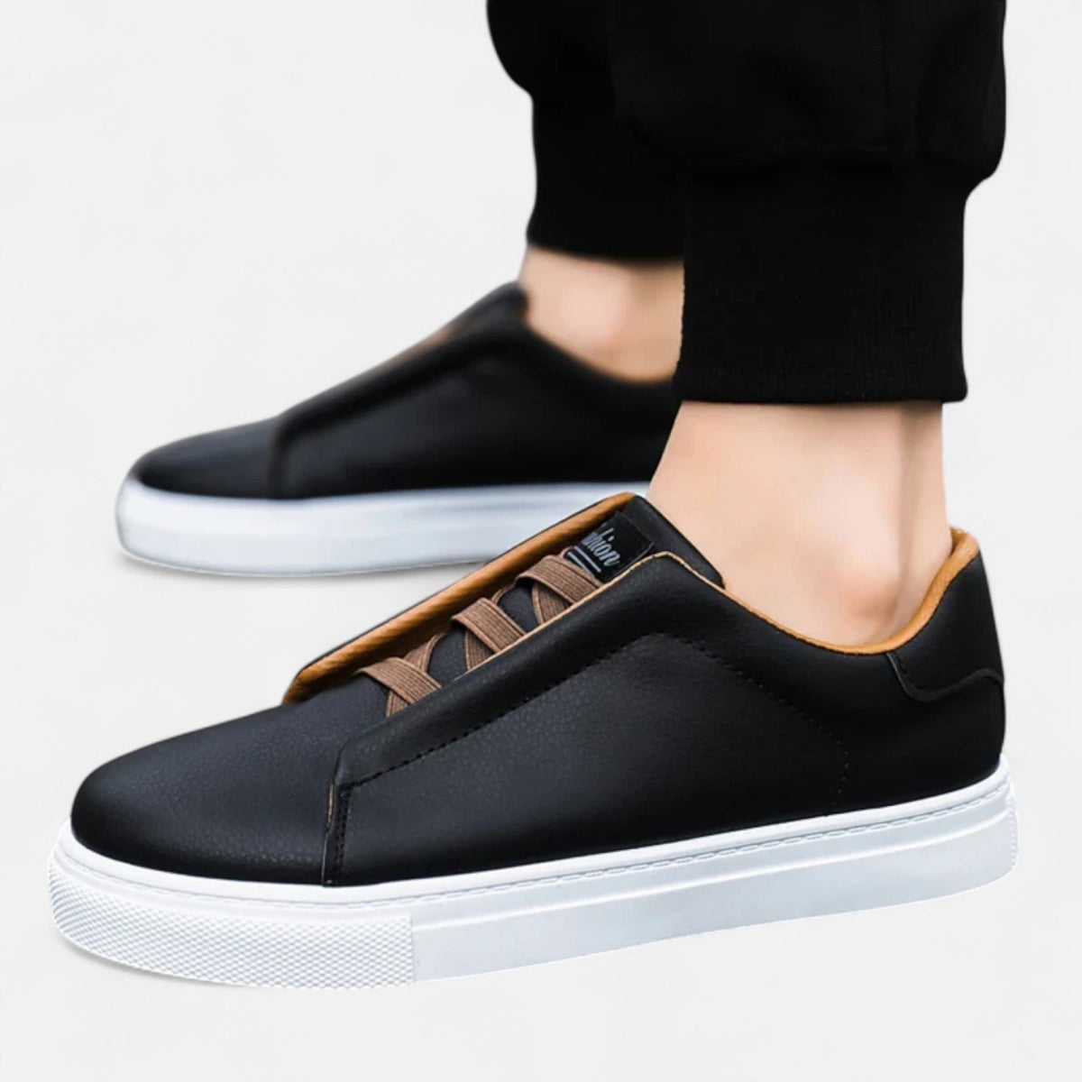 Men's low-top slip-on sneakers with stitched panels and flat white soles