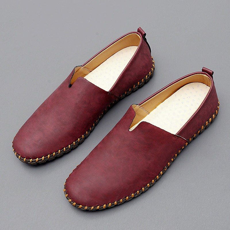 Slip-on loafers with rounded toes, flat soles and contrasting stitched trim