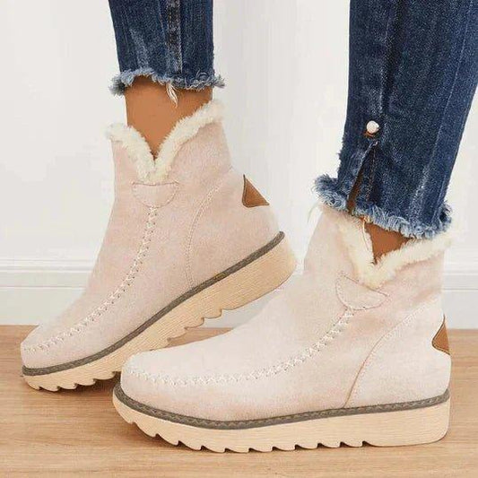 Women's short lined slip-on ankle boots with round toes, contrast trim and ridged platform soles