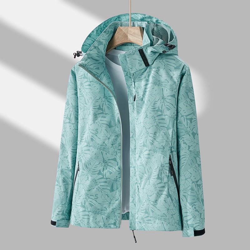 Women's hooded leaf print rain jacket with long sleeves and zipped pockets