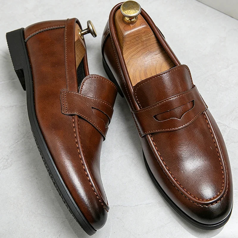 Men's penny loafers with almond toes and stitched apron detail