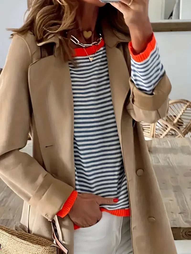 Women's black and white striped jumper with orange ribbed trim