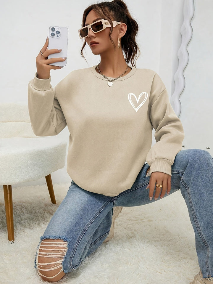 Women's crew neck sweatshirt with long sleeves and heart chest graphic