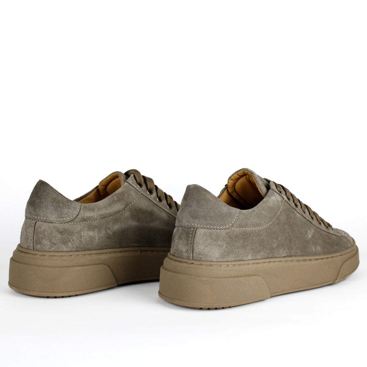 Taupe low-top lace-up sneakers with stitched panels and platform soles