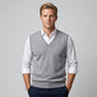 Men's sleeveless V-neck sweater vest layered over a collared shirt