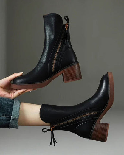 Women's heeled ankle boots with side zippers and tassel details