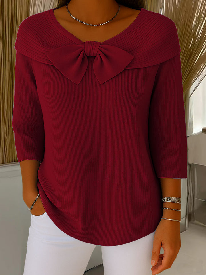 Women's ribbed sweater top with boat neckline and front bow