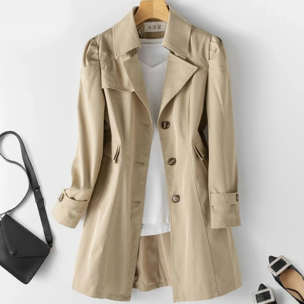 Women's belted double breasted trench coat with long sleeves and flap pockets
