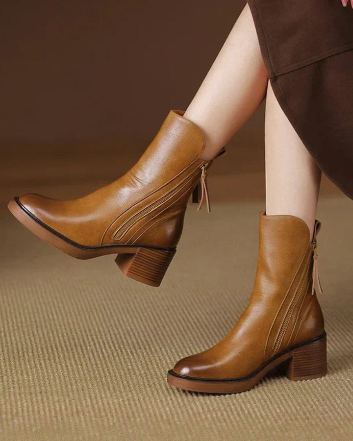 Women's heeled ankle boots with side zippers and tassel details