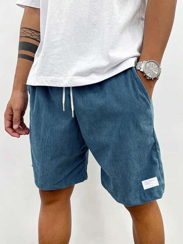 Men's blue corduroy shorts with drawstring waist, relaxed fit, worn with white t-shirt