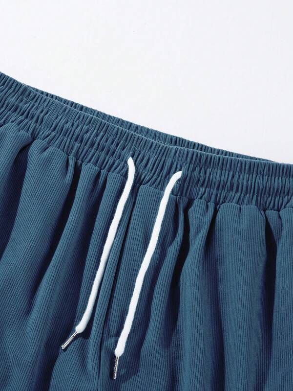Men's blue corduroy shorts with drawstring waist, relaxed fit, worn with white t-shirt