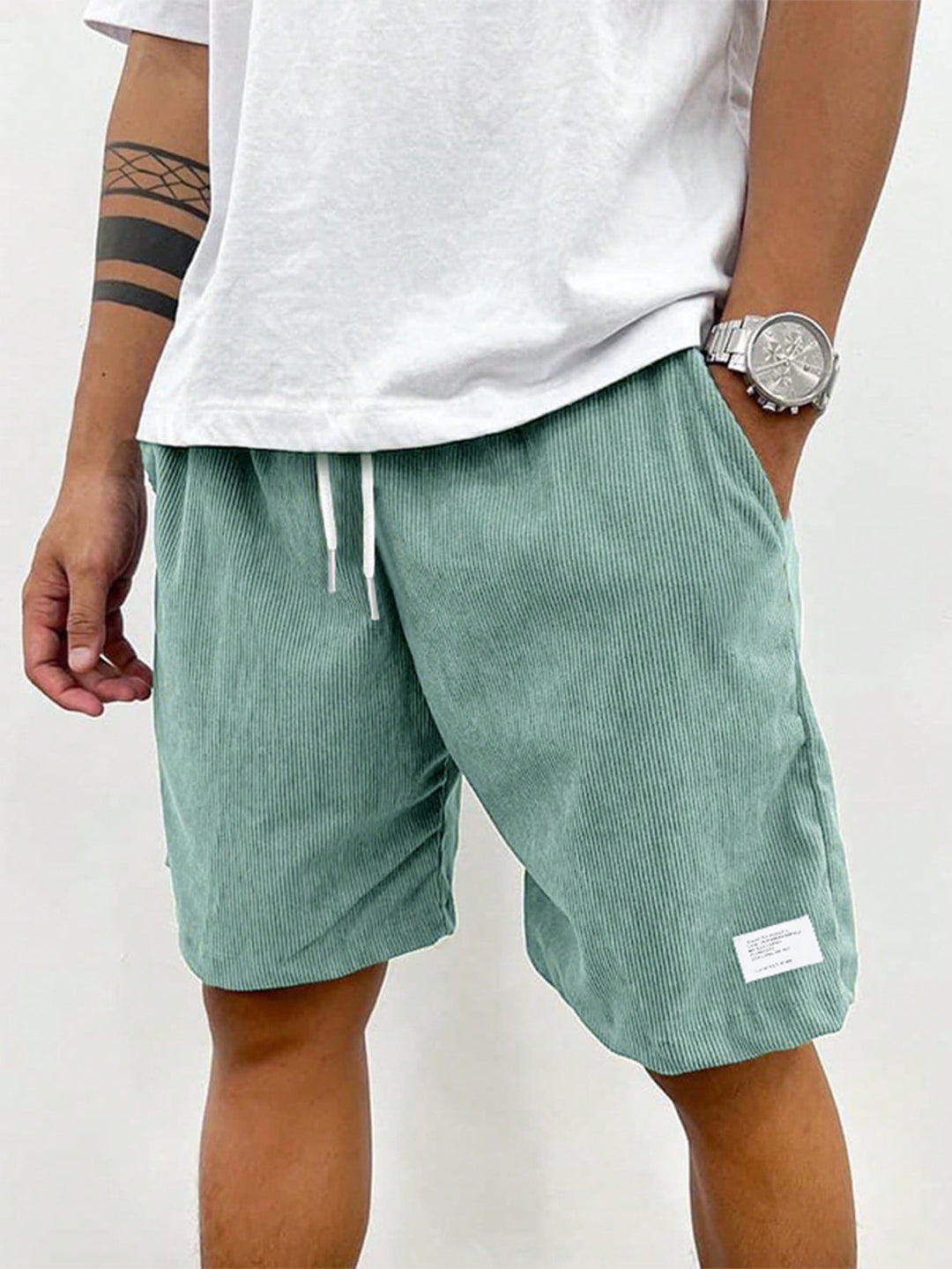 Men's blue corduroy shorts with drawstring waist, relaxed fit, worn with white t-shirt