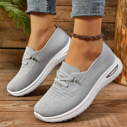 Grey women's slip-on sneakers with elastic lace detail and white soles