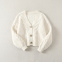 Women's cropped cable knit cardigan with V-neckline, buttons and long sleeves