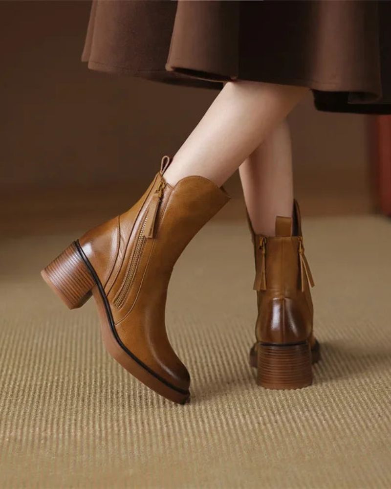 Women's heeled ankle boots with side zippers and tassel details