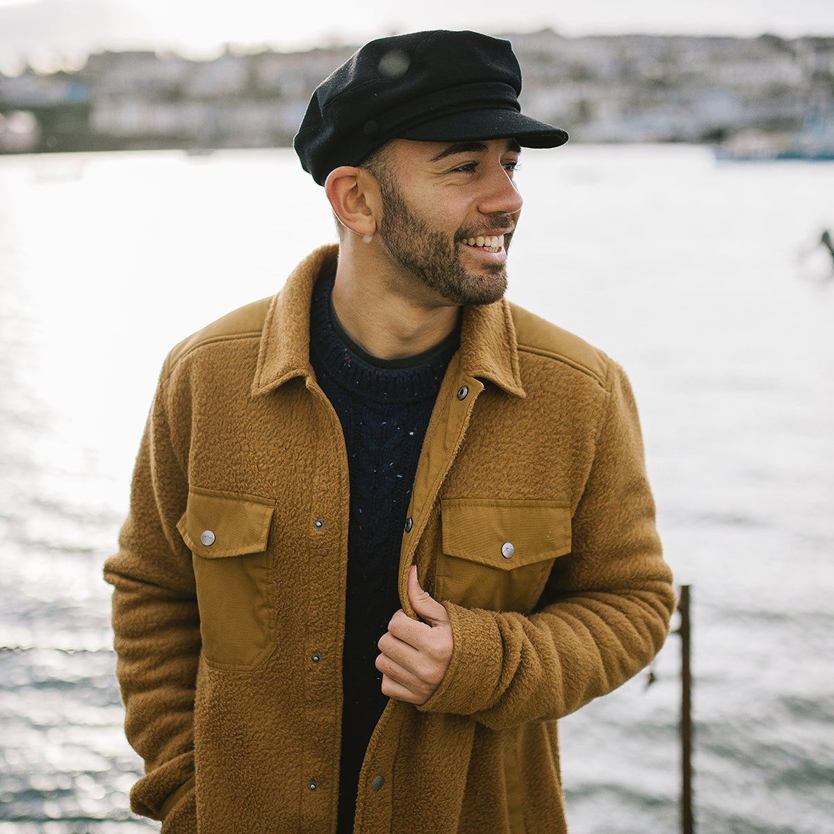 Black baker boy cap with structured crown, layered band and short brim