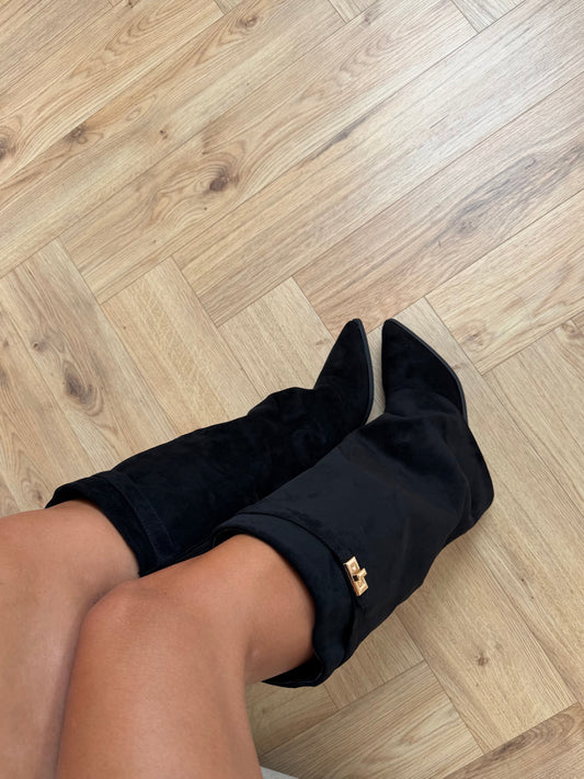Women's black knee-high boots with pointed toes, low heels and gold-tone buckle straps