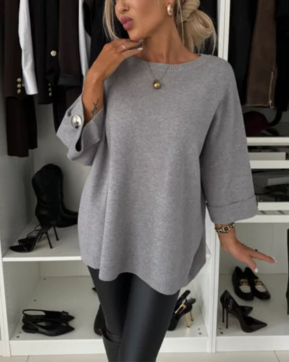 Women's solid round neck sweater with long sleeves and button cuff details