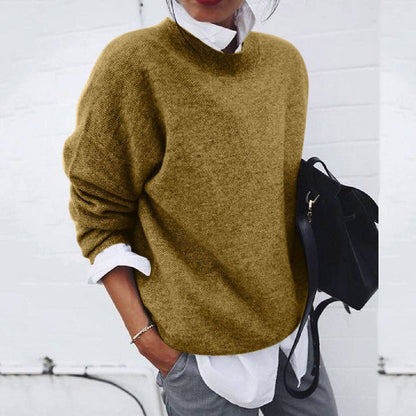 Women's relaxed crew neck sweater with long sleeves layered over a collared shirt