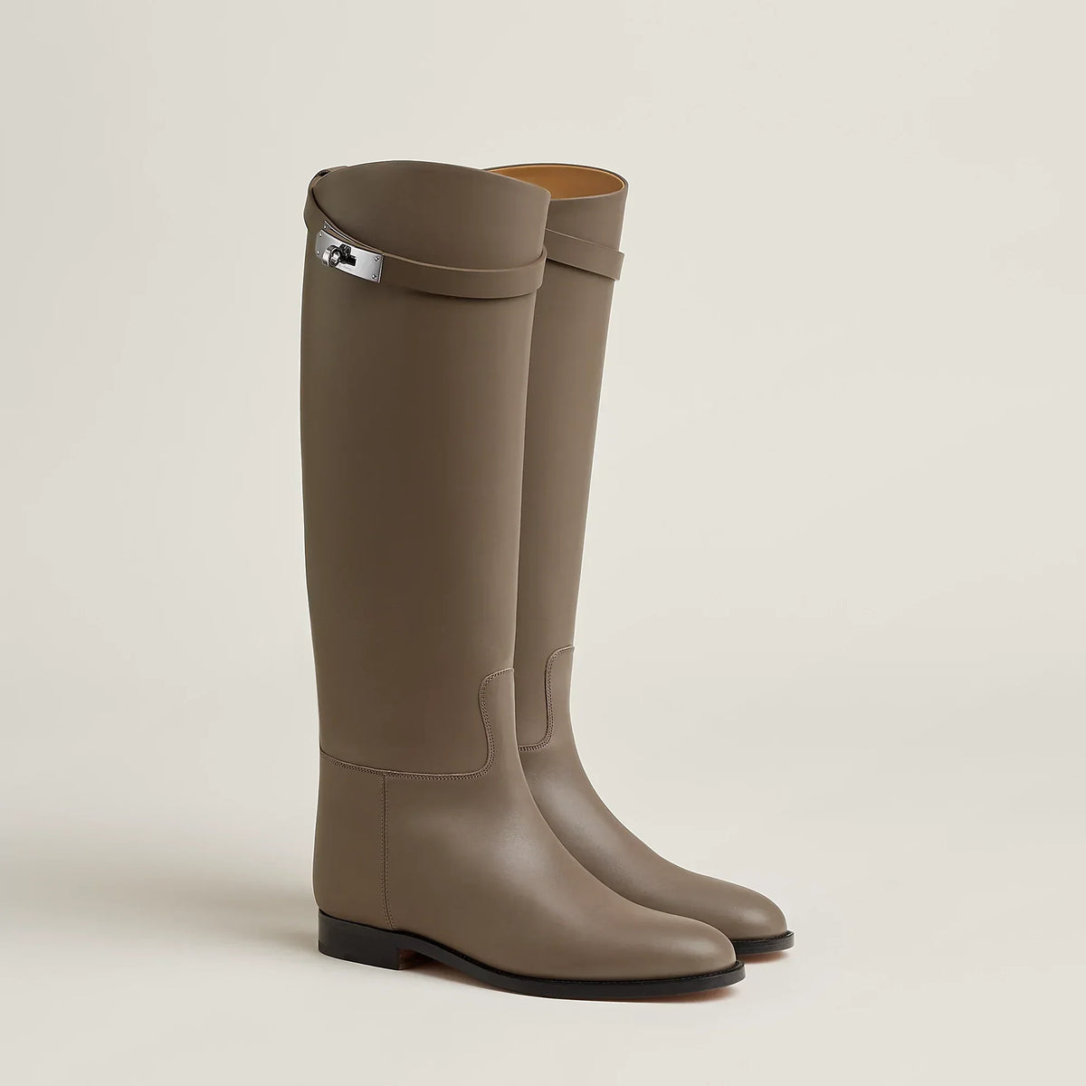 Women's tall riding boots with round toes, low heels and upper strap detail