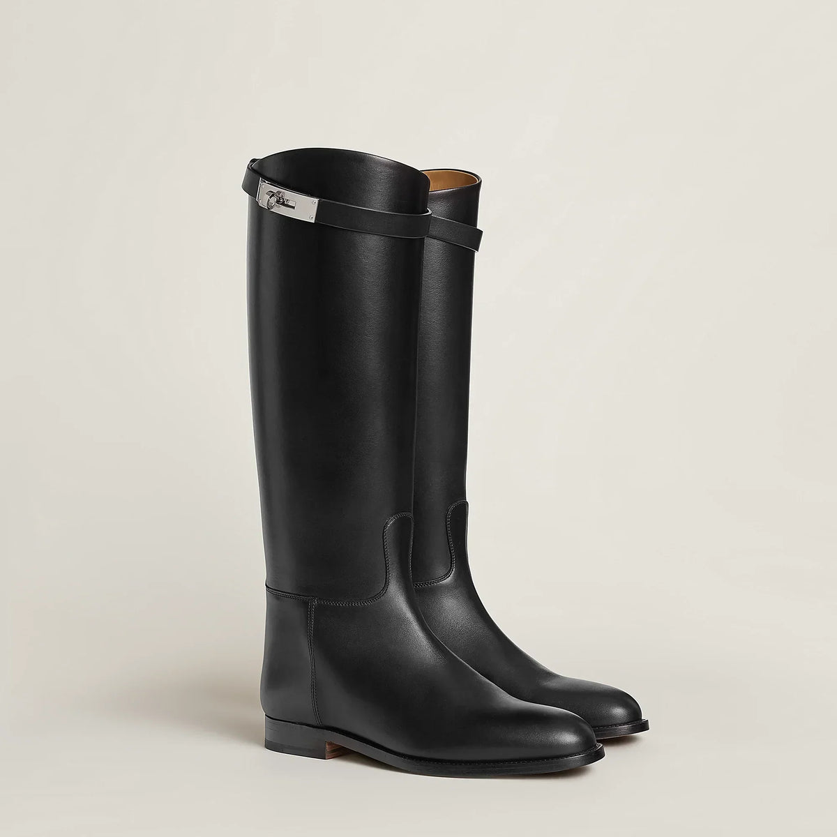 Women's tall riding boots with round toes, low heels and upper strap detail