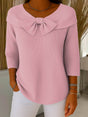 Women's ribbed sweater top with boat neckline and front bow