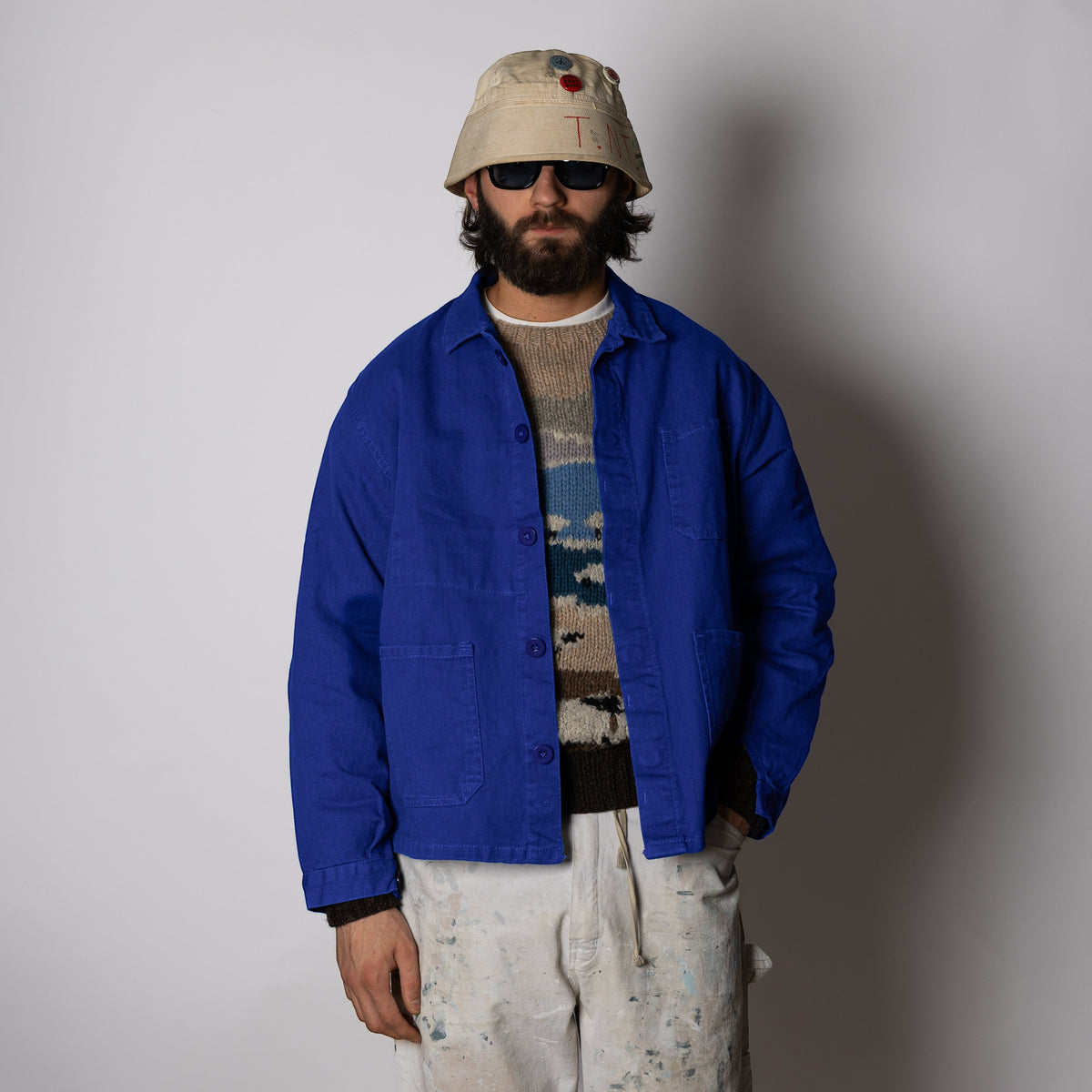 Men's blue button-front work jacket with collar and patch pockets