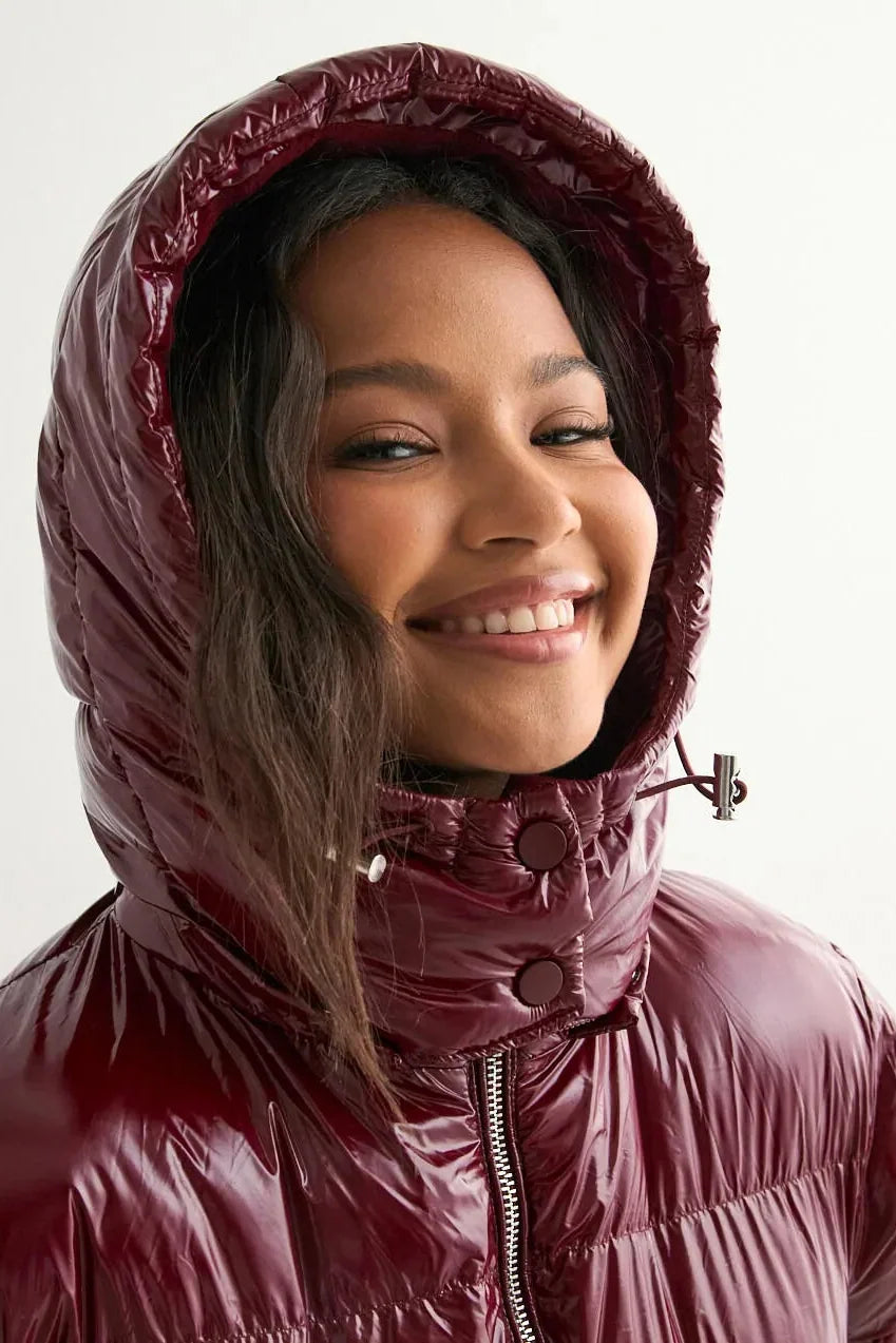 Women's glossy hooded puffer jacket with long sleeves and zip front