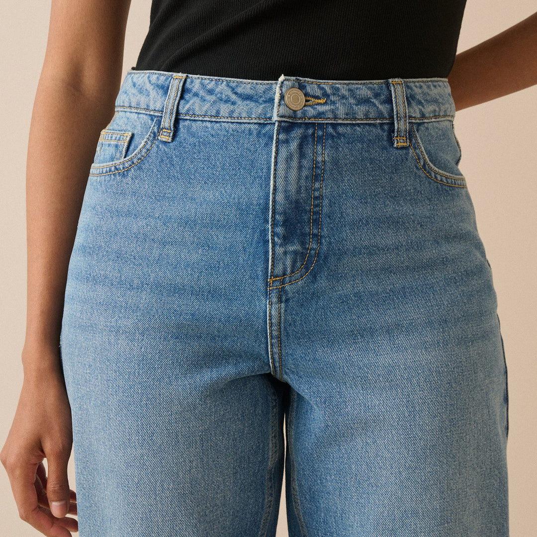 Women's blue barrel leg jeans with high-rise waist and cropped ankle-length hems