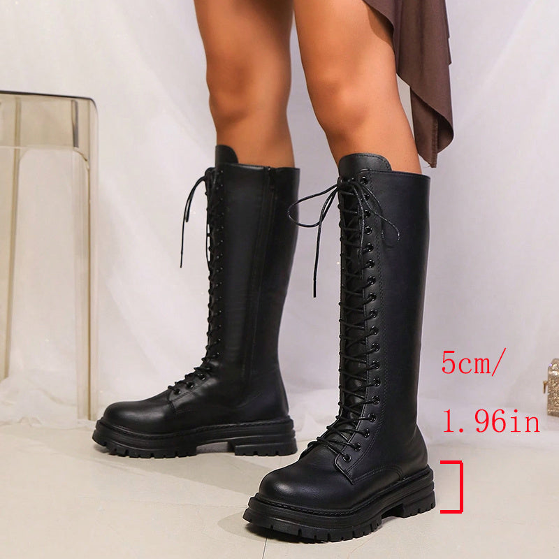 Black women's knee high lace-up platform boots with chunky lug soles