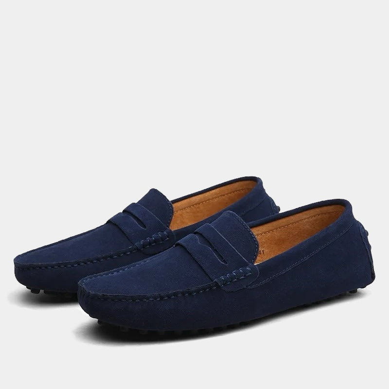 Pair of men's slip-on loafers with moc toe stitching and penny strap detail