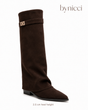 Women's brown knee-high boots with pointed toes, low heels and buckled shaft straps