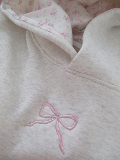 Light gray oversized hoodie with pink bow embroidery and floral hood lining