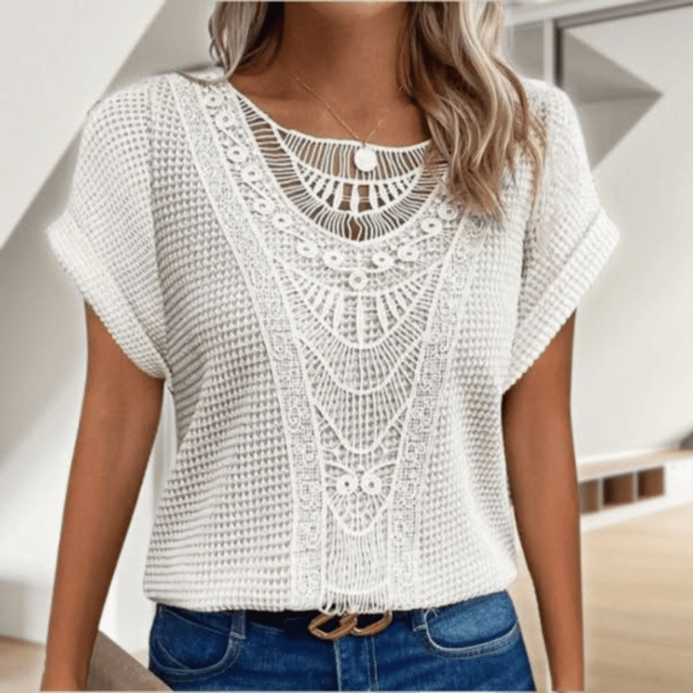 Woman wearing a relaxed waffle-knit top with an open crochet panel down the front and rolled cap sleeves