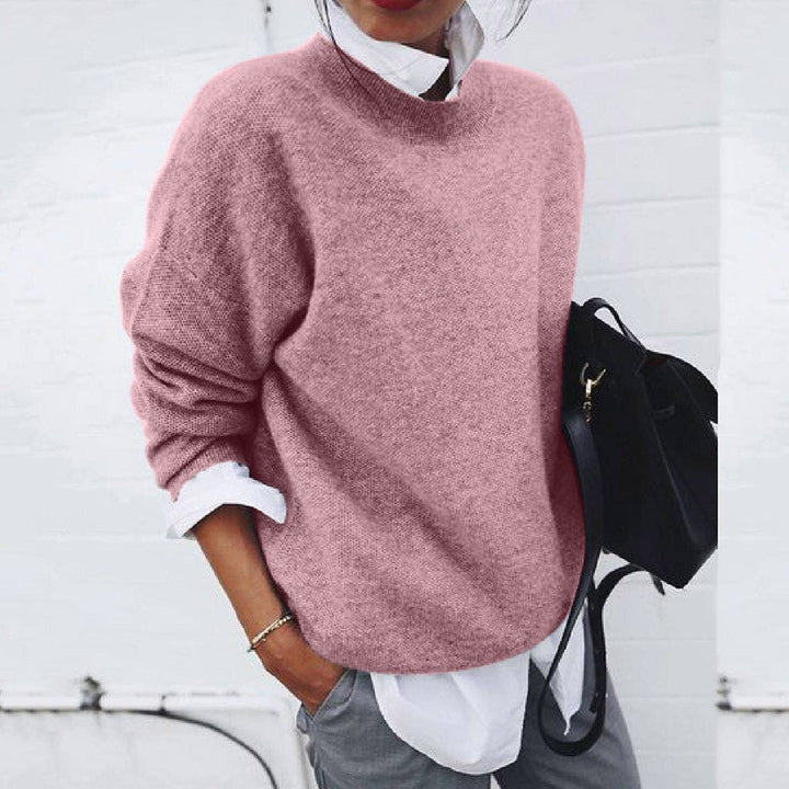 Women's relaxed crew neck sweater with long sleeves layered over a collared shirt