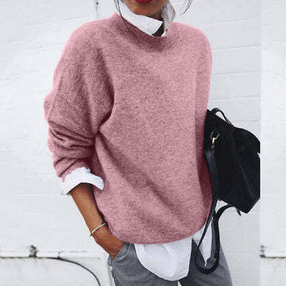 Women's relaxed crew neck sweater with long sleeves layered over a collared shirt