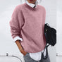 Women's relaxed crew neck sweater with long sleeves layered over a collared shirt