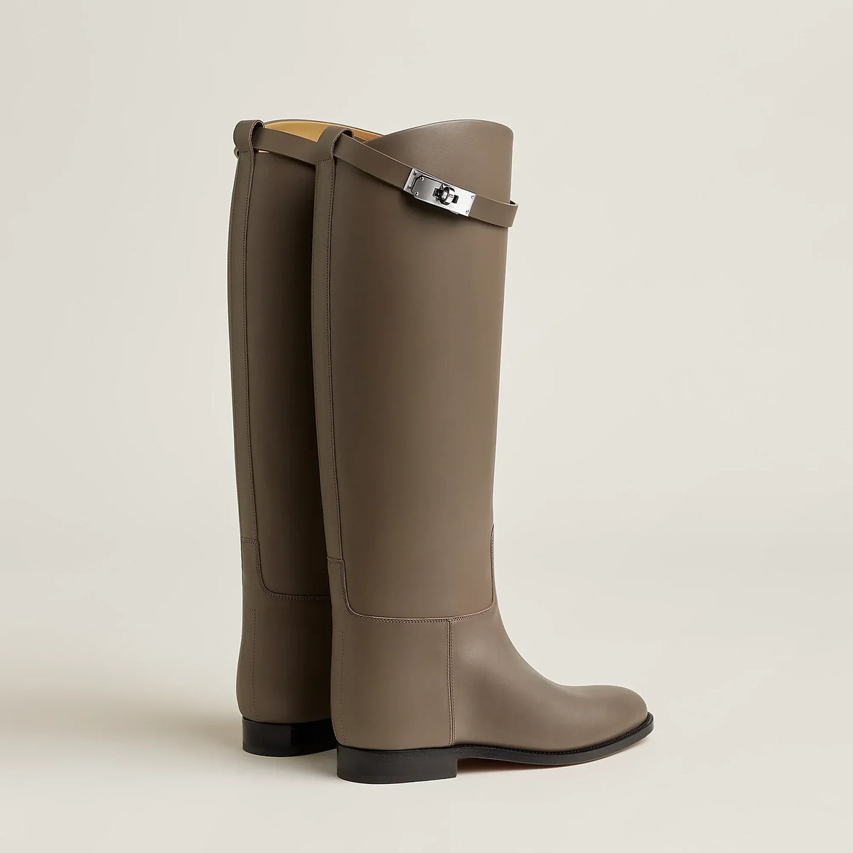 Women's tall riding boots with round toes, low heels and upper strap detail