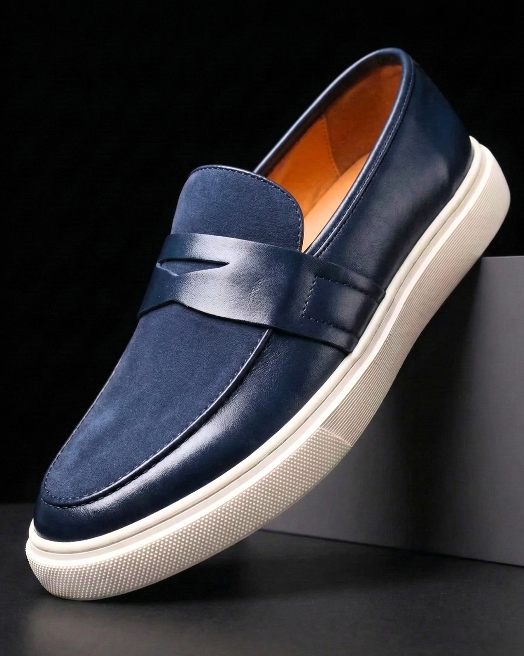 Slip-on penny loafer with textured vamp panel and flat contrast sole