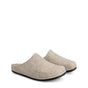 Beige open-back slip-on house slippers with rounded toes and black flat soles