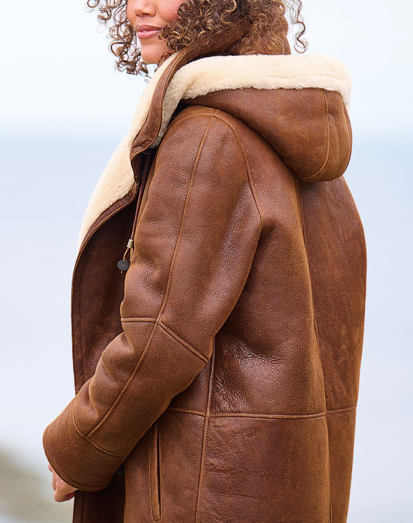 Women's brown hooded coat with cream trim and toggle fastenings