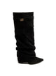 Black women's slouch knee-high boots with pointed toes and buckle details