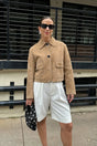 Women's beige cropped jacket with pointed collar, long sleeves and flap pockets