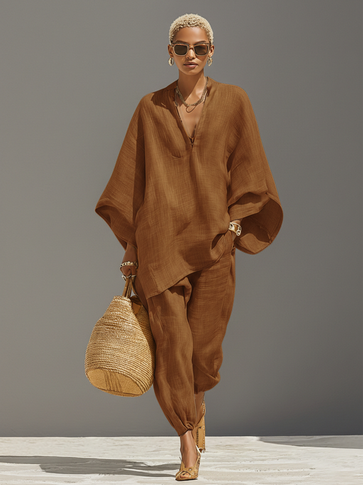 Women's textured beige asymmetric two-piece set with oversized shirt and tapered trousers