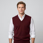 Men's sleeveless V-neck sweater vest layered over a collared shirt