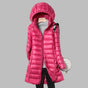 Women's hooded longline puffer coat with quilted panels and zip front